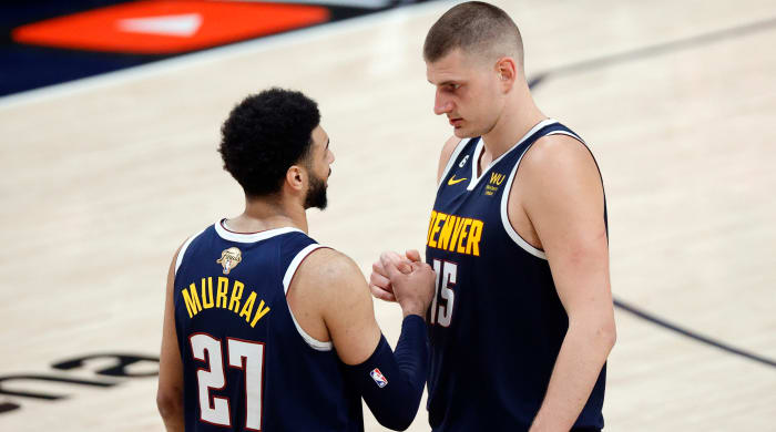 Nuggets center Nikola Jokic and guard Jamal Murray react to a play against the Heat in Game 2 of the NBA Finals.